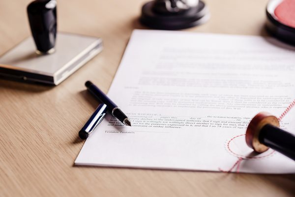 A pen resting on a legal document